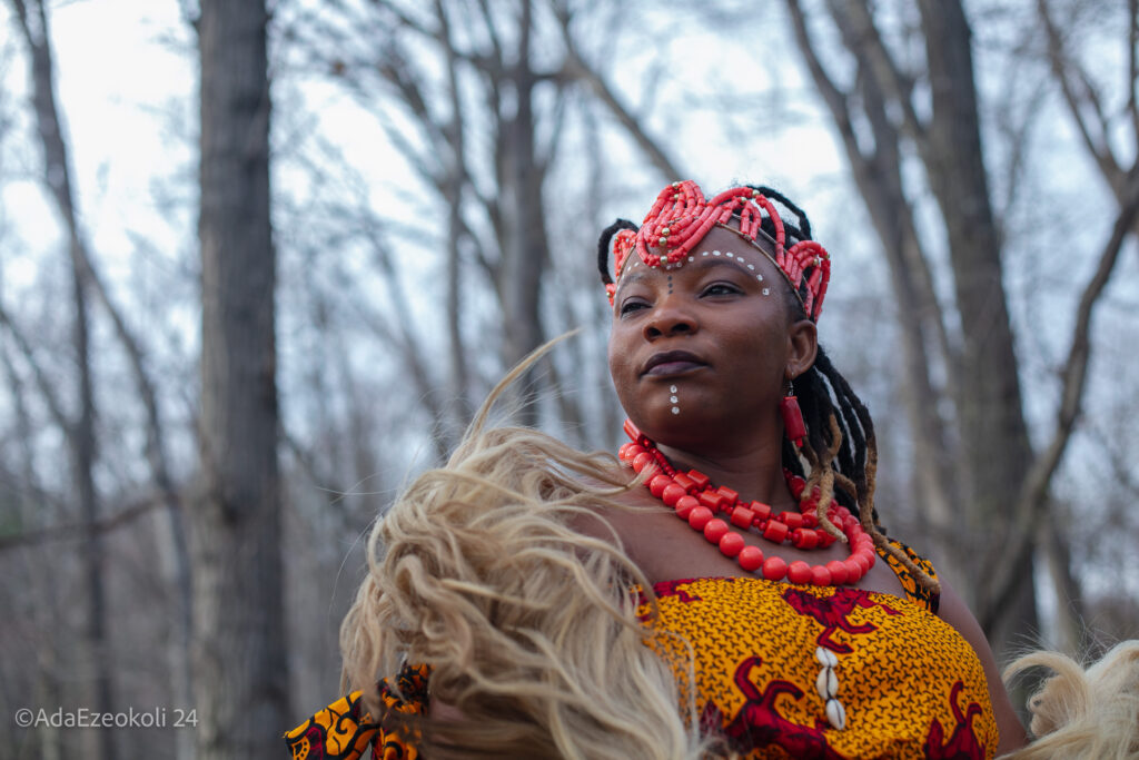 An Igbo African woman in a costume with a headdress.