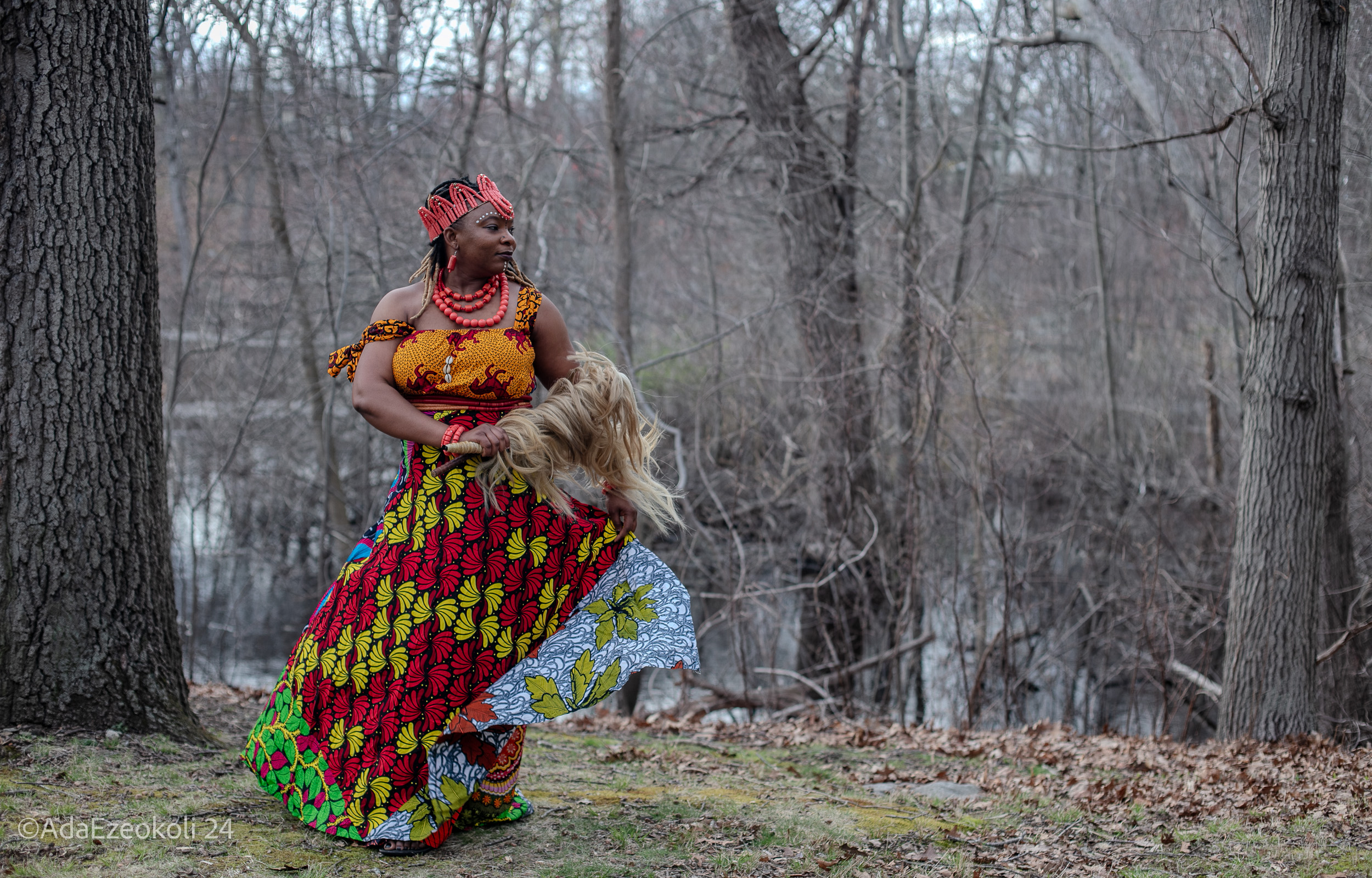 African-woman-costume.jpg An African woman in a costume and colorful headdress looking over her shoulder in the woods.