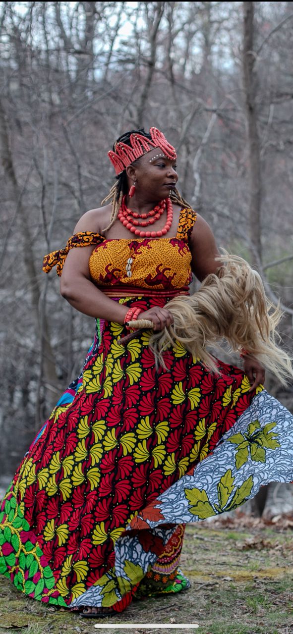 An African woman in a colorful costume and headdress