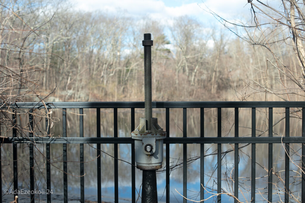 An iron rail in front of a lake