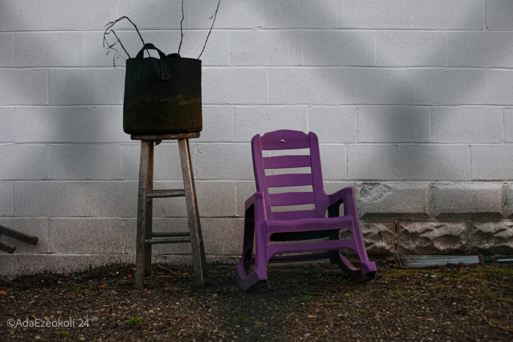 Purple rocking chair next to a stool