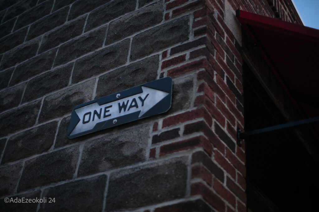 One way sign on a brick building