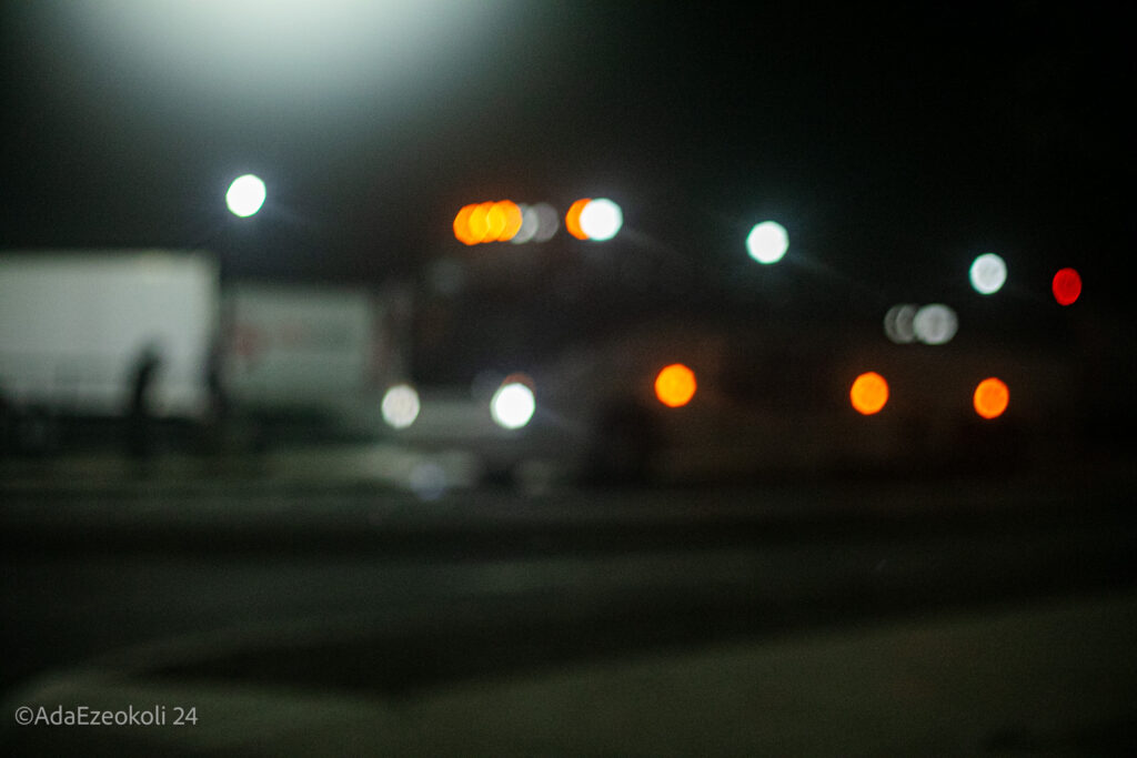 A bus with lights on in the dark