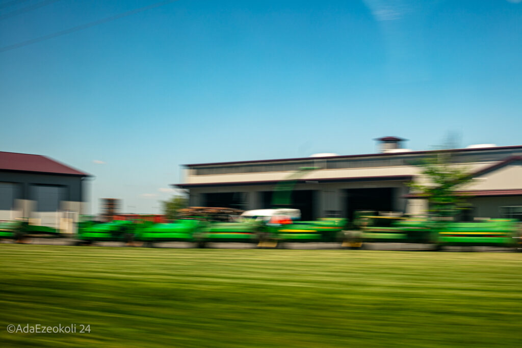 Blurred photo of green grass and tractors