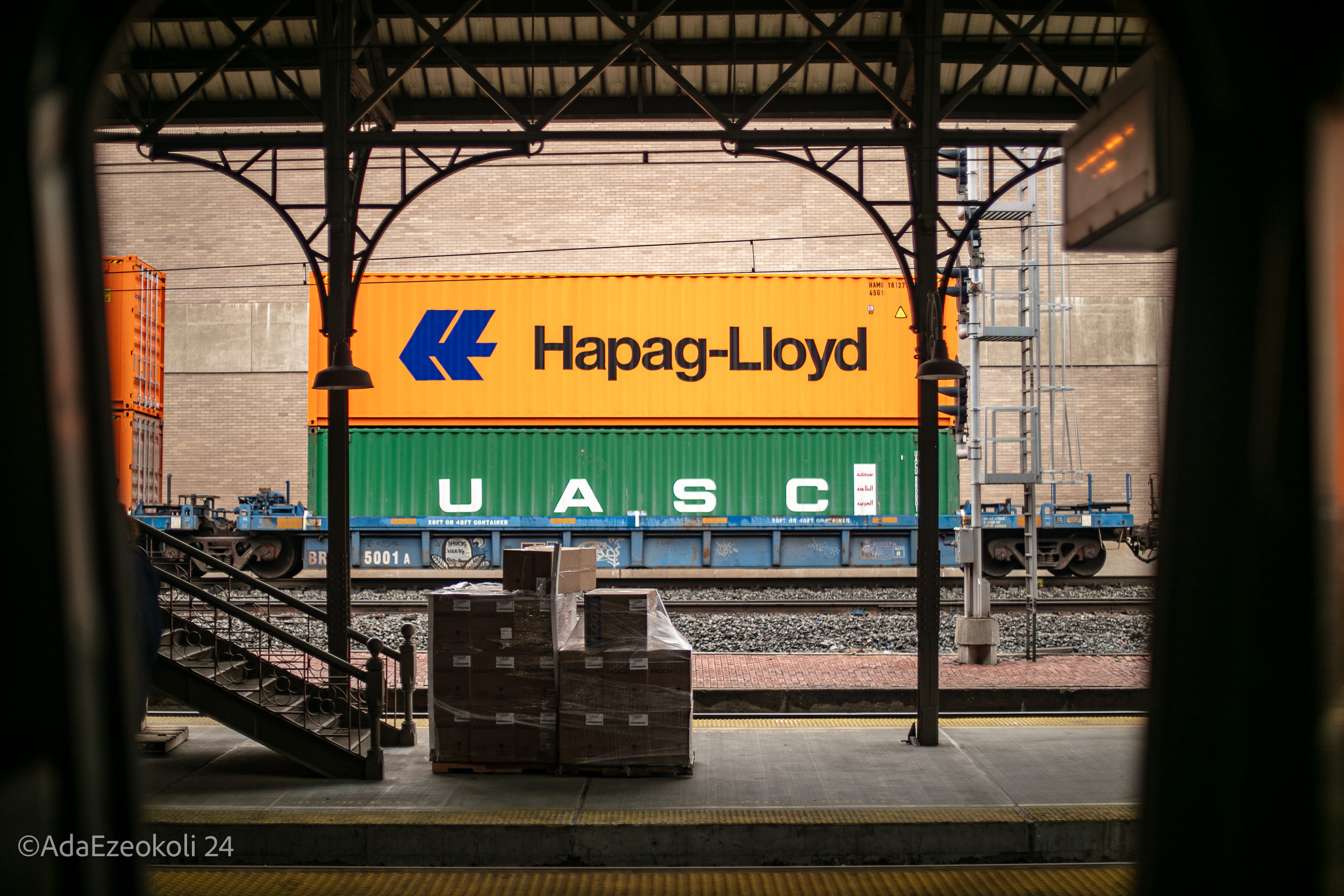 Cargo cars in frame outside a train window