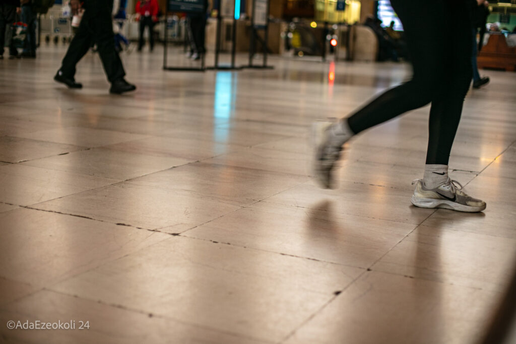 A woman's feet walking through a train terminal