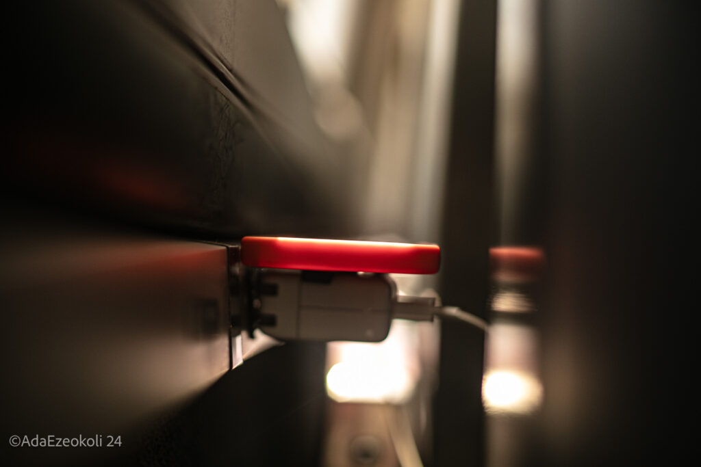 A phone plugged into a charger on the train.